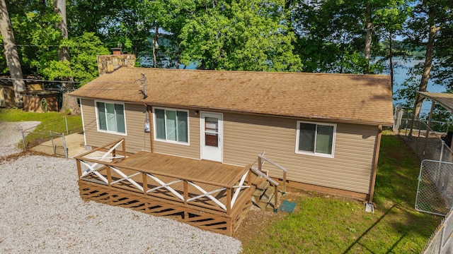 1336 Whites Creek Rd, Spring City, TN 37381 - rear view of property featuring a deck, fence, a shingled roof, and a chimney