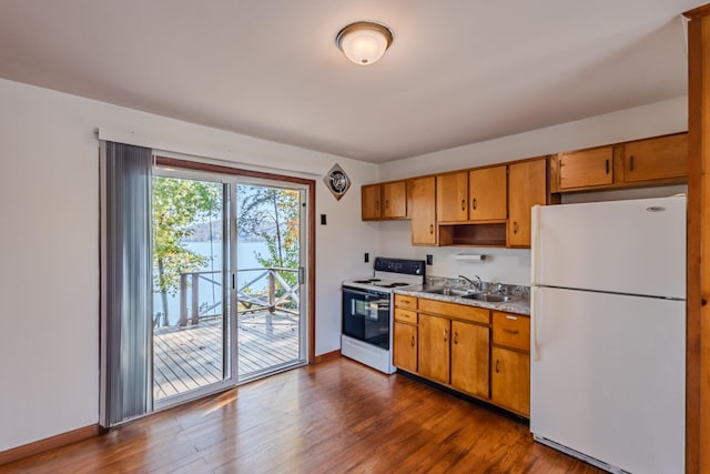 kitchen featuring sink, dark hardwood / wood-style floors, and white appliances