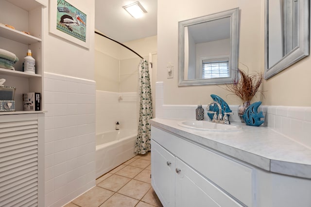 bathroom featuring tile patterned floors, vanity, tile walls, and shower / tub combo