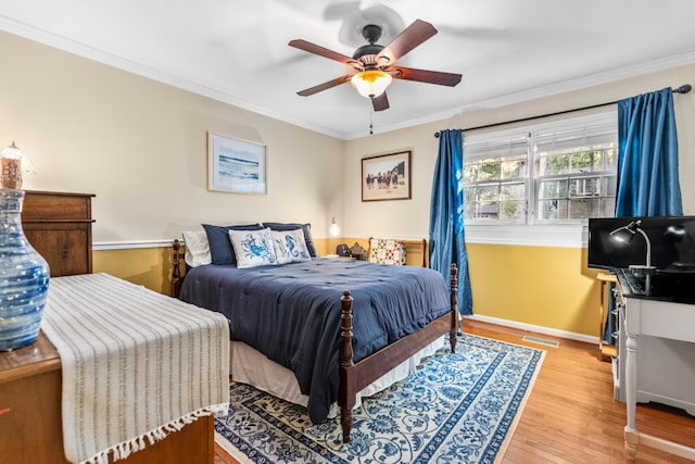 bedroom featuring ceiling fan, light hardwood / wood-style floors, and ornamental molding