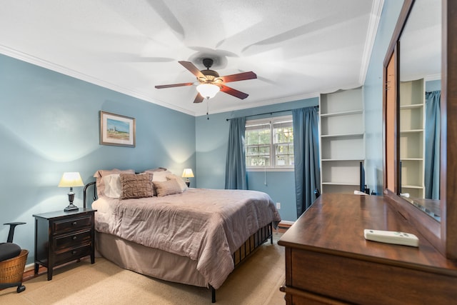 carpeted bedroom featuring ceiling fan and crown molding