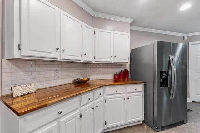 kitchen featuring white cabinets, stainless steel refrigerator with ice dispenser, and wooden counters