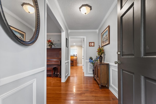 foyer with dark hardwood / wood-style flooring, ornamental molding, and a textured ceiling