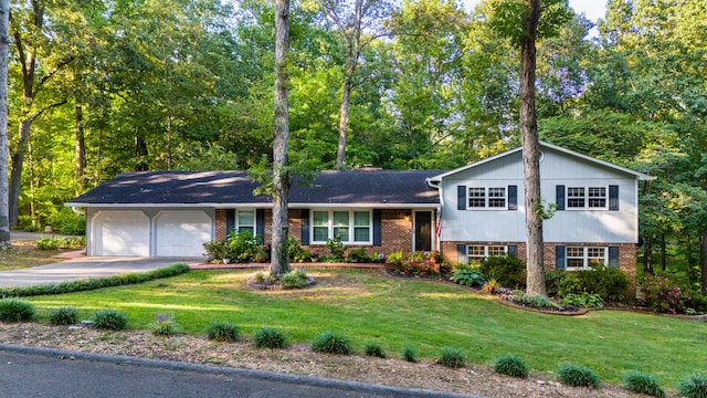 split level home with a front yard and a garage