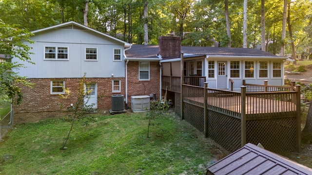 back of house with a deck, central AC unit, a lawn, and a sunroom