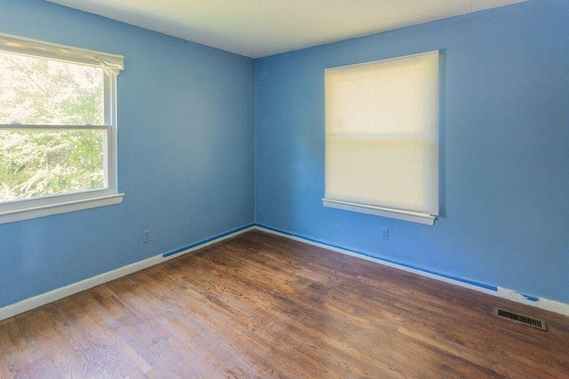 spare room with dark hardwood / wood-style floors