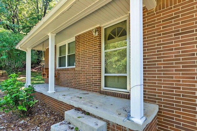 view of exterior entry featuring covered porch