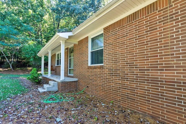 view of side of home with a porch