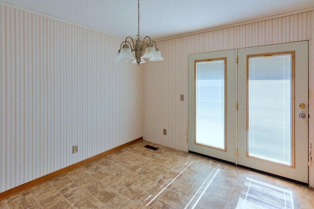 unfurnished dining area featuring a chandelier