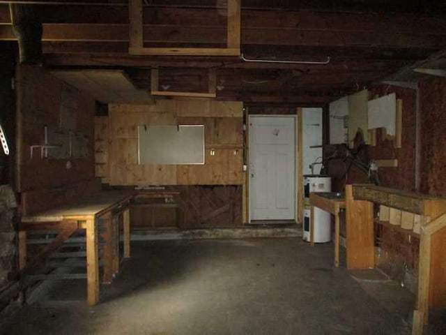 basement with a workshop area and water heater