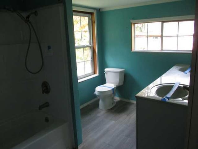 full bathroom with vanity, hardwood / wood-style floors, bathing tub / shower combination, and toilet