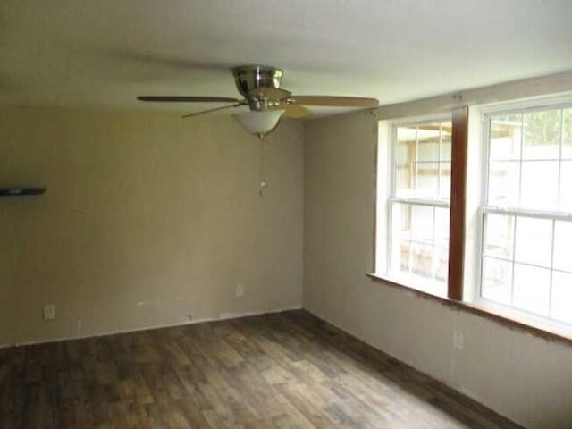 unfurnished room with ceiling fan and dark hardwood / wood-style flooring