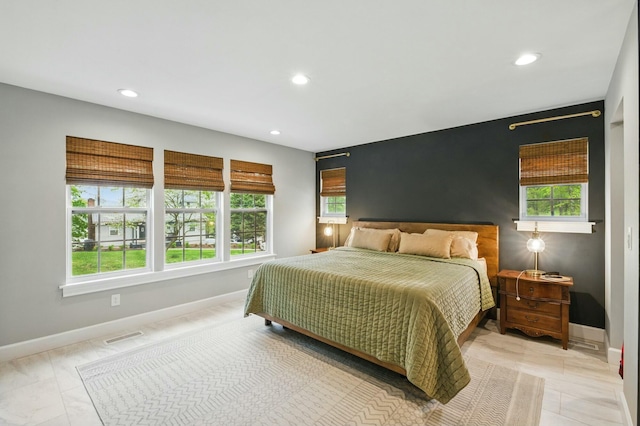 bedroom with multiple windows, baseboards, and recessed lighting
