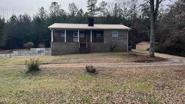 view of front of property with a front yard and a porch