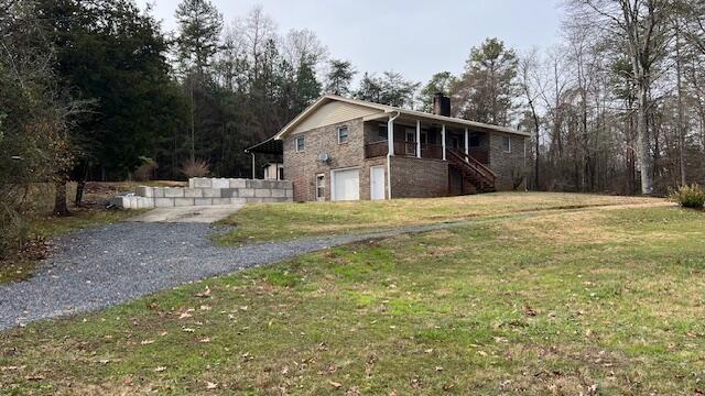 view of side of home featuring a garage and a yard