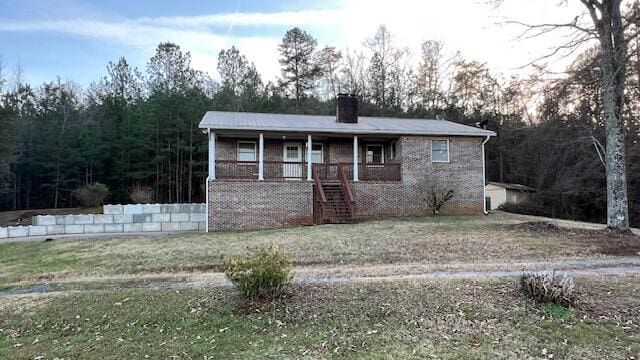 view of front of property with covered porch and a front yard