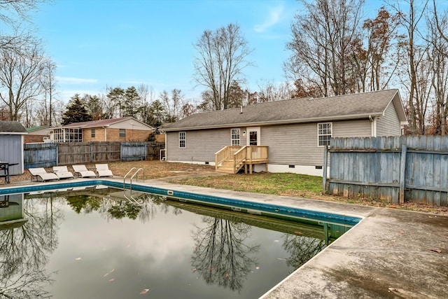 back of property featuring a fenced in pool