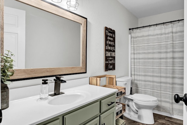 bathroom featuring vanity, toilet, wood-type flooring, and walk in shower