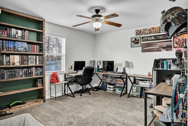 carpeted home office featuring ceiling fan