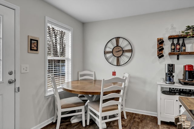 dining space with dark hardwood / wood-style flooring