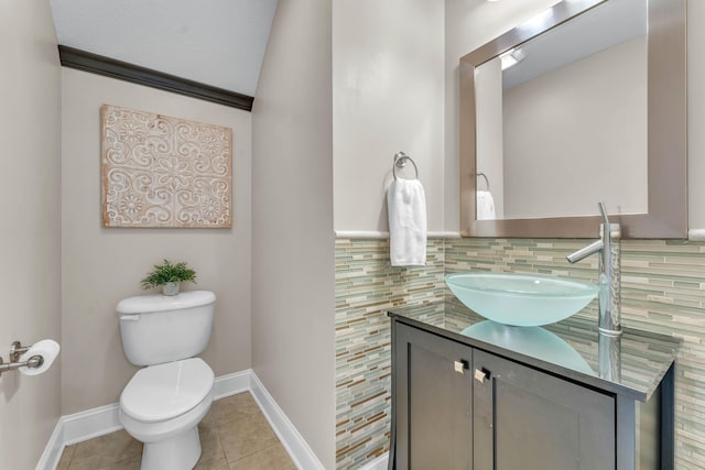 bathroom featuring decorative backsplash, tile patterned flooring, vanity, and toilet