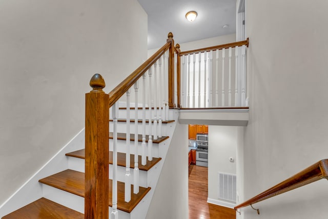 stairs with hardwood / wood-style flooring