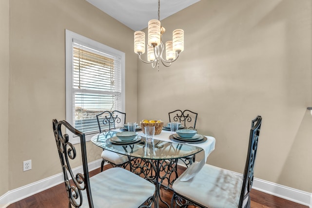 dining room with a chandelier and dark hardwood / wood-style floors