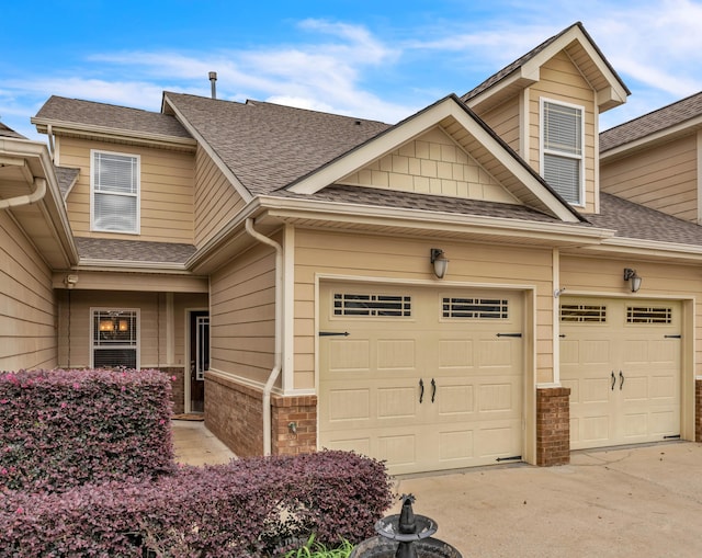 5414 Mandarin Cir, Hixson, TN 37343 - view of front of house featuring driveway, roof with shingles, an attached garage, and brick siding