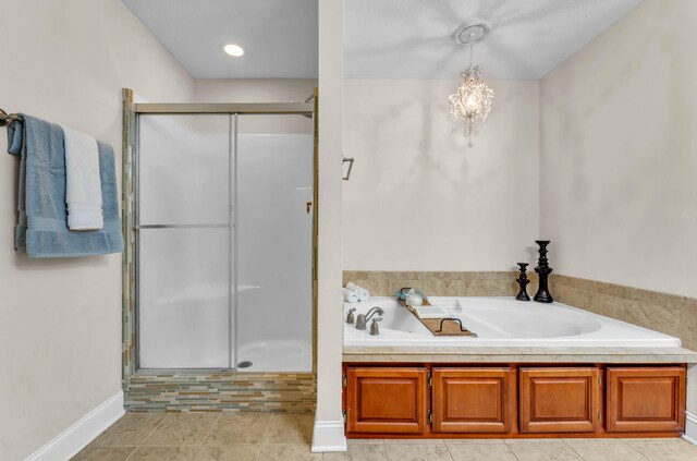 5414 Mandarin Cir, Hixson, TN 37343 - full bathroom featuring a shower stall, a garden tub, a chandelier, and baseboards
