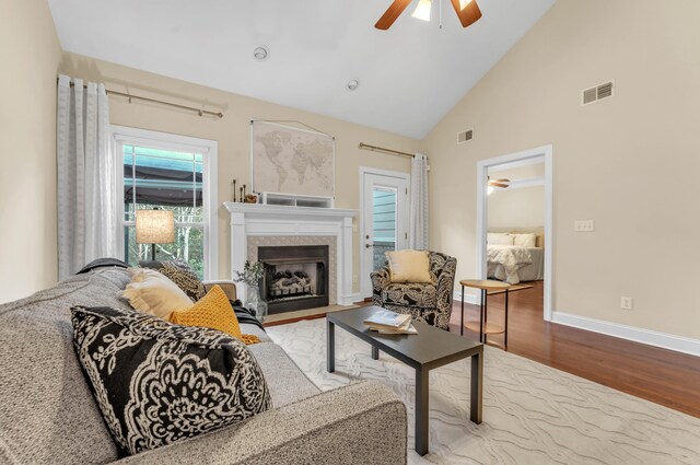 5414 Mandarin Cir, Hixson, TN 37343 - living area featuring a ceiling fan, wood finished floors, high vaulted ceiling, a fireplace with flush hearth, and baseboards