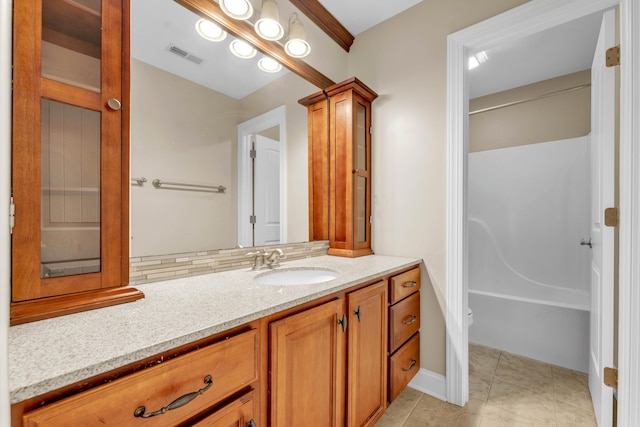 bathroom featuring tile patterned floors, vanity, and decorative backsplash