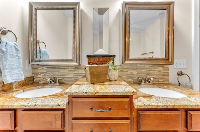 bathroom with vanity and tasteful backsplash