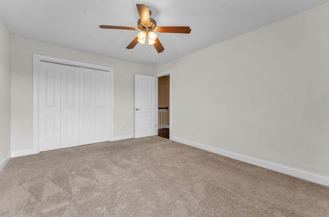 unfurnished bedroom with ceiling fan, carpet floors, and a closet