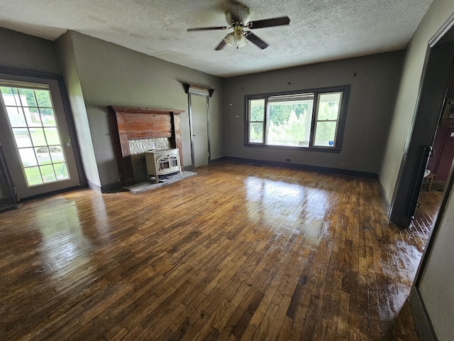 2783 No Pone Rd NW, Georgetown, TN 37336 - unfurnished living room featuring a wood stove, hardwood / wood-style floors, a ceiling fan, a textured ceiling, and heating unit