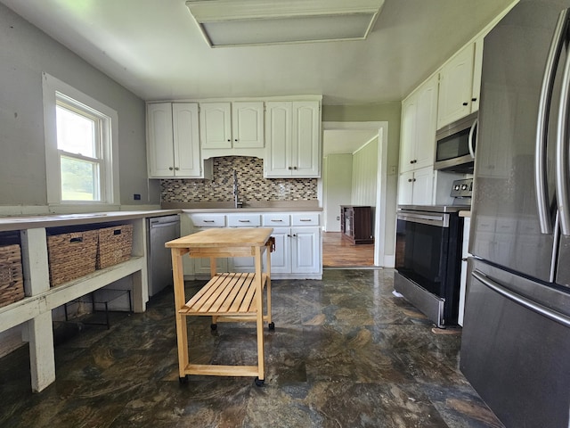 2783 No Pone Rd NW, Georgetown, TN 37336 - kitchen with appliances with stainless steel finishes, white cabinetry, light countertops, and decorative backsplash