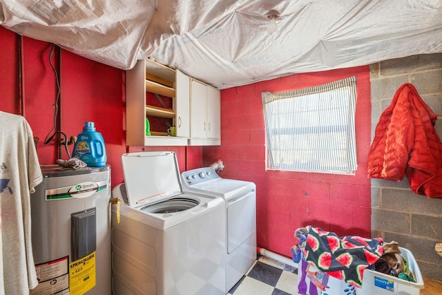 laundry area with tile patterned floors, cabinet space, water heater, and washer and clothes dryer