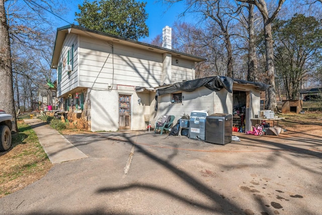 rear view of property with a chimney