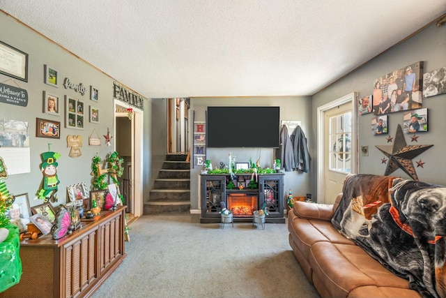 living area with stairs, carpet floors, and a textured ceiling