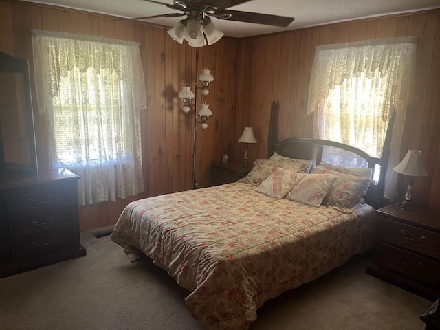 2510 Railroad St, Dayton, TN 37321 - carpeted bedroom with multiple windows, a ceiling fan, and wood walls