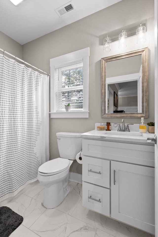 bathroom featuring vanity and toilet