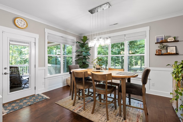 dining room with dark wood-type flooring and ornamental molding