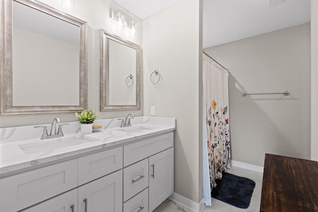 bathroom with curtained shower and vanity