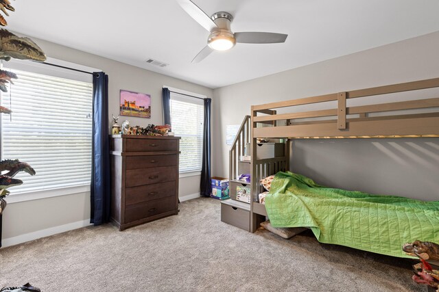 bedroom with ceiling fan and light carpet