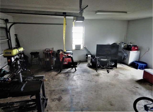 garage featuring cooling unit and a garage door opener