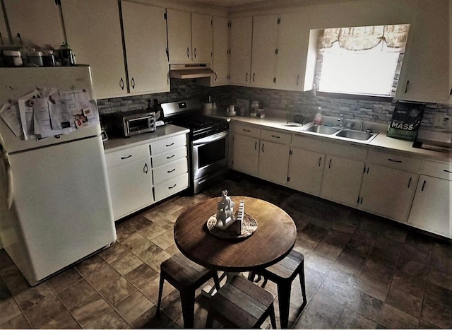 kitchen with white cabinetry, sink, tasteful backsplash, white fridge, and stainless steel electric stove