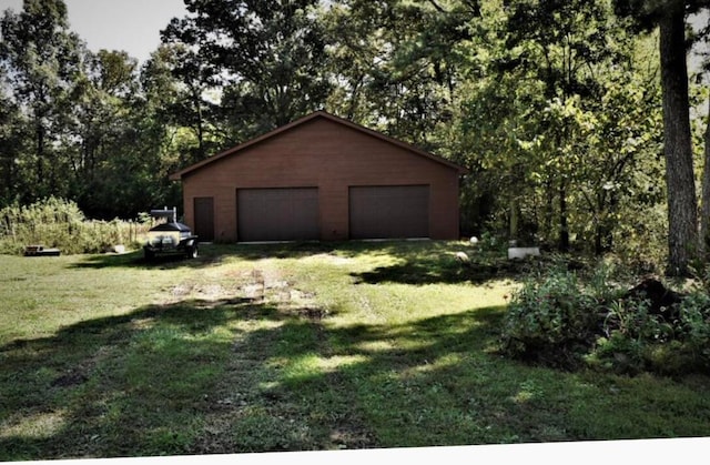 garage featuring a lawn