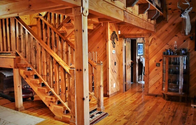 interior space featuring hardwood / wood-style floors and wood walls