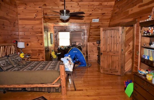 bedroom with hardwood / wood-style flooring and lofted ceiling