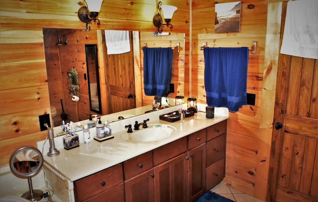 bathroom with wood walls, tile patterned flooring, and vanity