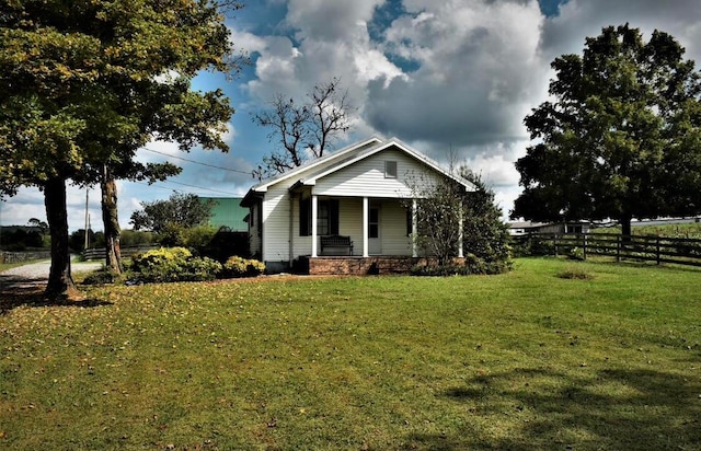 view of front of home featuring a porch and a front yard